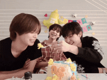 a group of young men are celebrating a birthday with a cake and a balloon that says one year 09