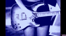 a woman is playing a guitar in a video that says vev at the bottom