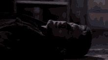 a man is laying on the floor with his eyes closed .