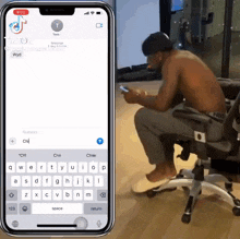 a shirtless man is sitting in an office chair looking at his cell phone