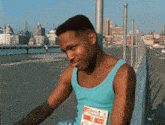 a man in a blue tank top is holding a magazine that says double incest