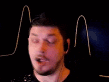 a man with a beard wearing headphones is looking at something
