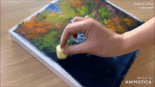 a person is painting a picture with medium yellow and sap green paints
