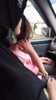 a girl in a pink shirt is being held by a man in a black shirt with the word always on it