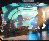 a man in a trench coat is holding a light saber in front of a very large window