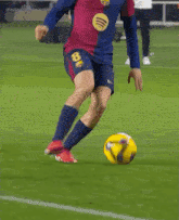 a soccer player with the number 8 on his shorts kicking a ball