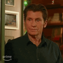 a man in a black shirt says yup in front of a picture frame