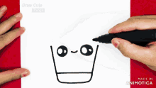 a person is drawing a face with a marker on a piece of paper that says " draw cute things "