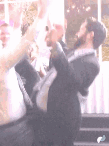 a man in a suit is dancing with a woman