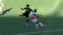 two soccer players are hugging each other on a soccer field