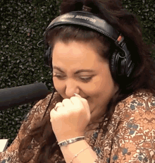 a woman wearing a pair of headphones with the word audio on it
