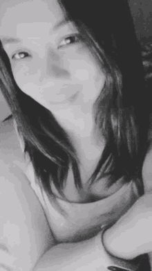 a black and white photo of a smiling woman