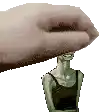 a hand is holding a statue of a woman with a bottle in her head .
