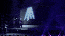purple lights are shining on a stage with a sign that says ' a & r ' on it