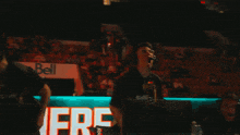 a man wearing headphones in front of a bell sign