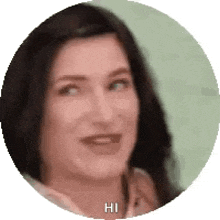 a close up of a woman 's face in a circle with the words `` hi '' written on it .