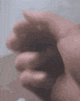 a close up of a person 's hand with a blurred background