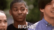 a group of people are standing next to each other and one of them is making a funny face .