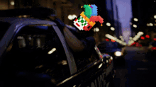 a man in a police car has a pixelated image of a person on his head
