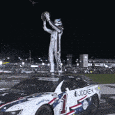 a jockey race car with a man on top of it