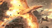 a car is exploding in a huge explosion with a lot of fire coming out of it .