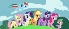 a group of ponies are standing on a grassy hillside