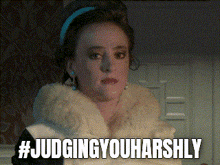 a woman in a fur coat with the words # judgingyouharshly above her