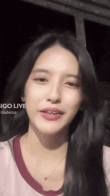 a close up of a woman 's face with the words " indigo live " behind her