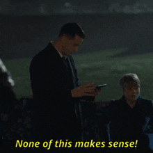 a man in a suit stands next to a woman with the words none of this makes sense on the bottom