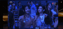 two women sitting at a table with a lazada logo on the bottom right
