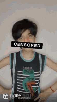 a boy wearing a shirt that says censored