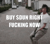 a man walking down a street with the words buy $ dun right fucking now on the bottom