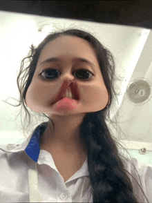 a girl making a cartoon face with a fan in the background