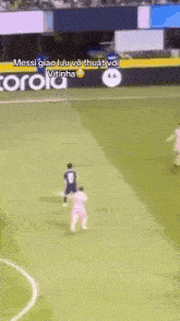 a soccer game is being played on a field with a motorola advertisement in the background