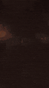 a large explosion with sparks coming out of it in the dark
