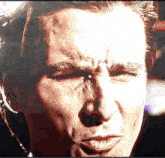 a close up of a man 's face with a smirk on it