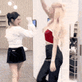 two women are standing next to each other in a room with the words lnr archive on the bottom right