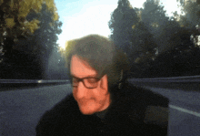 a blurry picture of a man wearing glasses