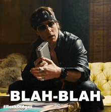 a man sitting on a couch with the words blah-blah written on the bottom