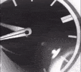a black and white photo of a clock with roman numerals and a white border