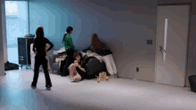 a woman sitting on a couch in a room with other people