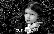 a little girl is pointing at something in a black and white photo and says `` cut her off '' .