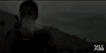a woman is smoking a cigarette with the letters xbl on the bottom right