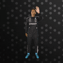 a man in a petronas racing suit is dancing