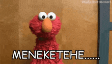 elmo from sesame street is standing in front of a wooden wall and saying menektehe .