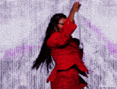 a woman in a red dress is dancing in front of a white background