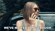 a woman talking on a cell phone with the words " we 've waited long enough " above her