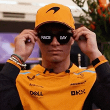 a man wearing a hat and sunglasses with race day written on them