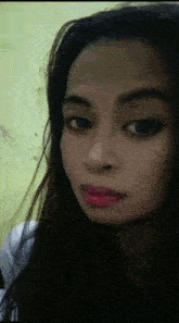 a close up of a woman 's face with dark hair and red lipstick