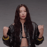 a woman wearing a black jacket with the letter p on the sleeves